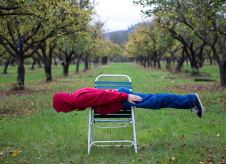 Teenager lying down on chair